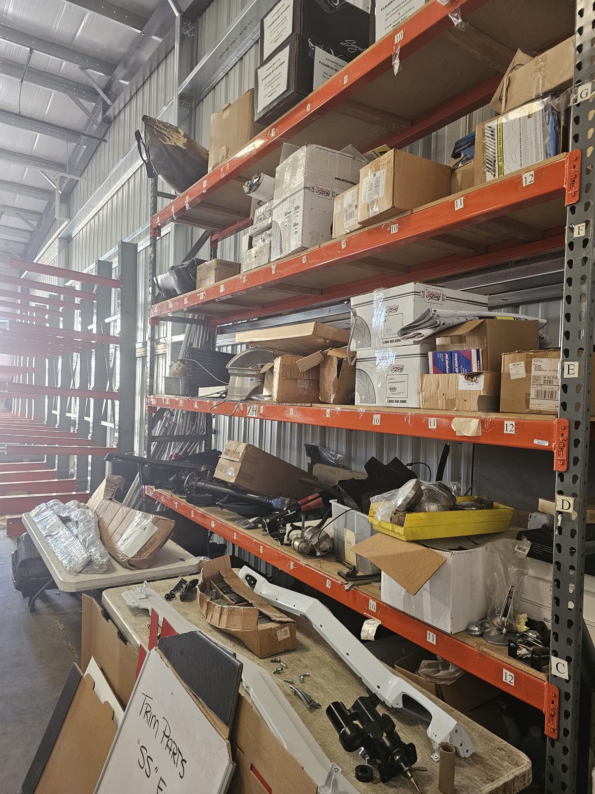 Shop racks and staging tables where incoming parts land